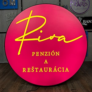 Circular pink sign with yellow 'Riva' logo and the words 'Penzión a reštaurácia', indicating a pension and restaurant.